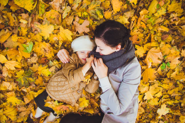 istock Young mother and her daughter have fun at autumn 1336809677
