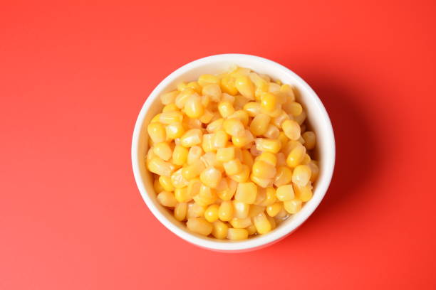 istock Bowl of sweet corn in white bowl  on red background 1336809977