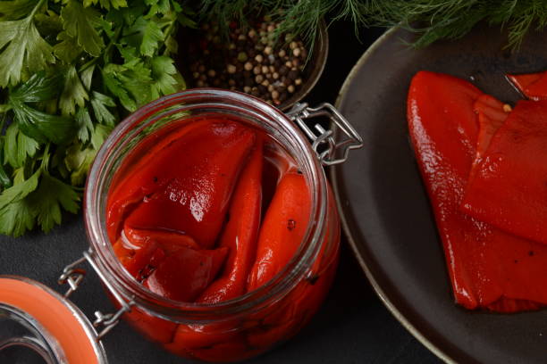 Delicious sweet red pepper pickles. Preserved, marinated red sweet peppers Delicious sweet red pepper pickles. Preserved, marinated red sweet peppers red bell pepper stock pictures, royalty-free photos & images