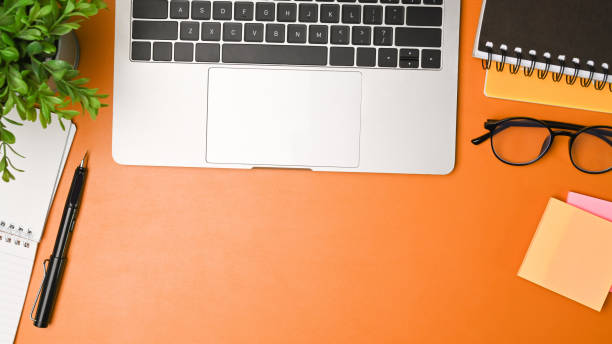istock Stylish workspace with laptop computer, glasses, notebook and houseplant. 1336814220