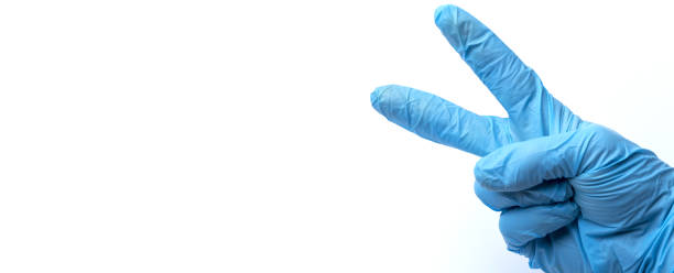 istock A gloved hand holding up two fingers. Place under the text, 1336814500
