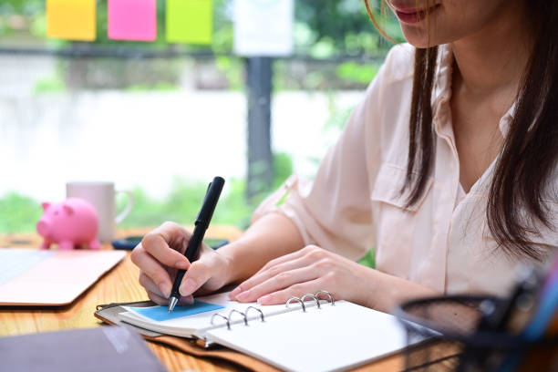 istock Cropped shot businesswoman making note on notebook. 1336815190