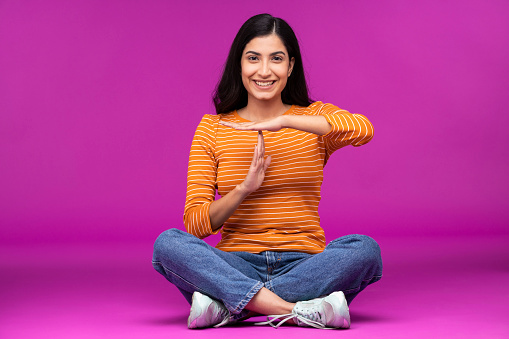 Young woman on purple background