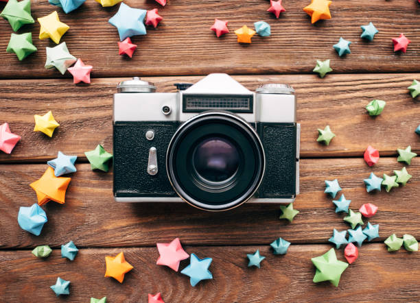 istock Analog vintage retro camera on a wooden table. 1336821264