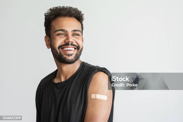 Man Showing His Vaccinated Arm With Plaster Got Covid19 Vaccine Stock Photo - Download Image Now