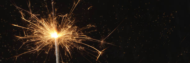 istock Close view of sparkler on black background. soft selective focus. abstract bokeh background, copy space. 1336826107