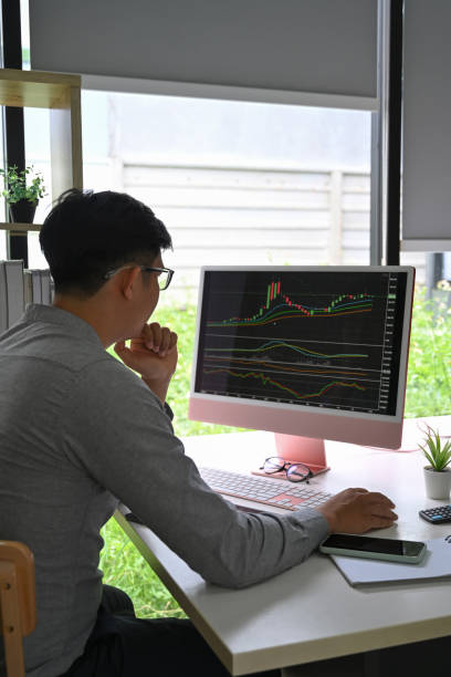 istock Successful trader working with charts and market reports on computer screen in modern office. 1336826675