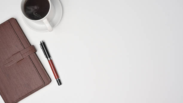 istock A coffee cup, notebook and pen on white background with copy space. 1336833879
