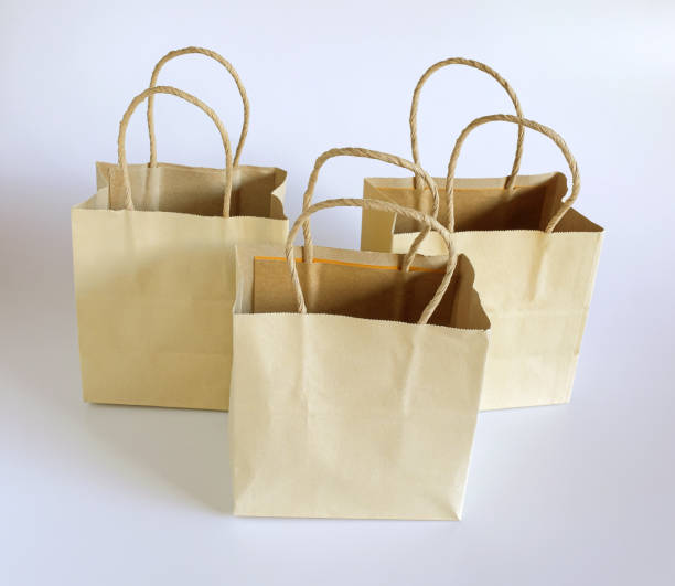 istock Brown paper shopping bag on background. 1336834040