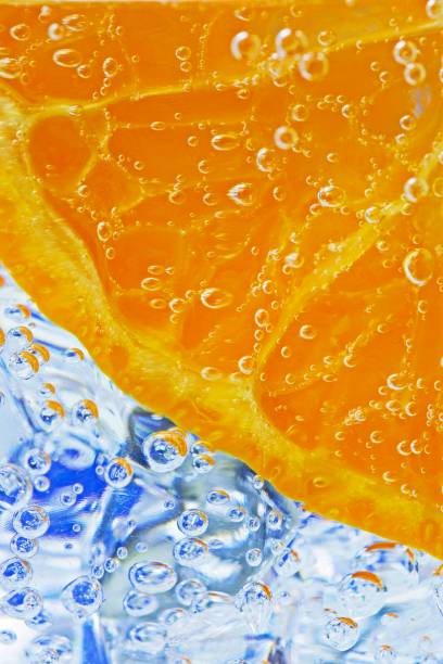 istock Orange slice and ice cubes with bubbles in cold carbonated drink. 1336837266