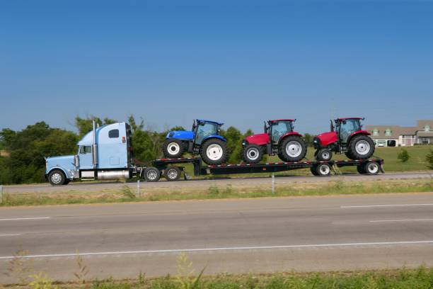 istock Lorry truck transport with three agriculture tractor 1336837377