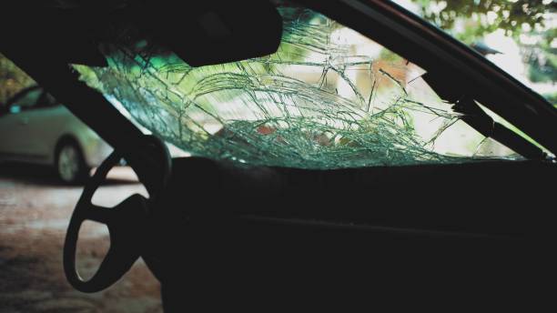 interior of wrecked car with windshield shattered in a serious hit and run accident abandoned in forest - hit and run imagens e fotografias de stock