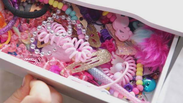 Young Caucasian Girl Opening Small Cabinet Drawer full of Hairstyle Accessories and Picking Colorful Hair Band and Clip Young Caucasian Girl Opening Small Cabinet Drawer full of Hairstyle Accessories and Picking Colorful Hair Band and Clip hair clip stock pictures, royalty-free photos & images