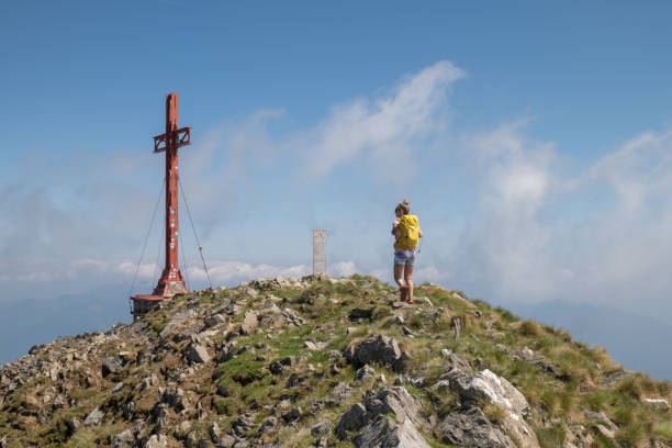 istock Woman hiking on mountain ridge, clouds 1336840332