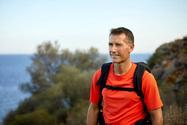 istock Confident mature man hiking in forest 1336842789