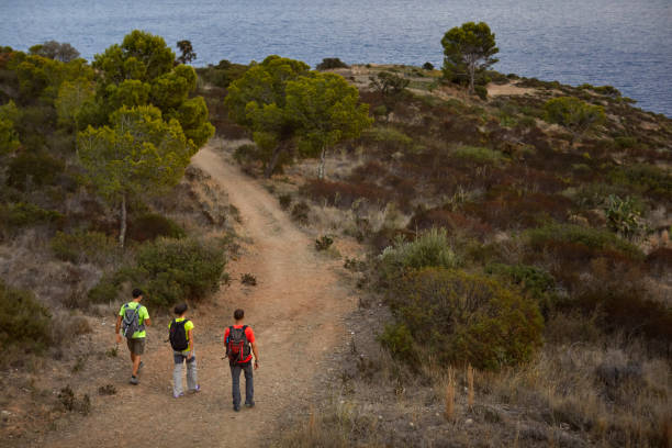 istock Backpackers hiking together on dirt road 1336843092