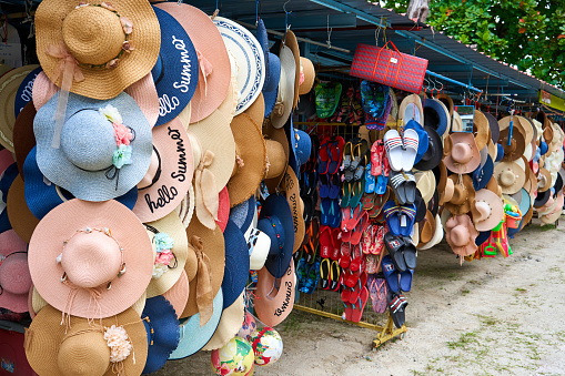 Shop with hats of various styles in the street market. Showcase with hats. Langkawi, Malaysia - 07.04.2020