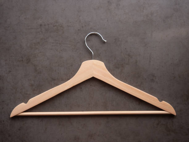 istock Wooden clothes hanger on a dark background. 1336851339