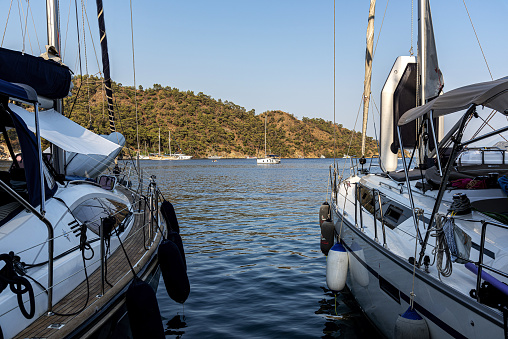 Nature scene with other boats in the sea visible between two sailing boats in Gocek bays, Turkey.
