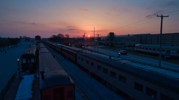 istock Sunrise With Blue, Red Sky and Clouds Looking Over a Train Station 1336854239