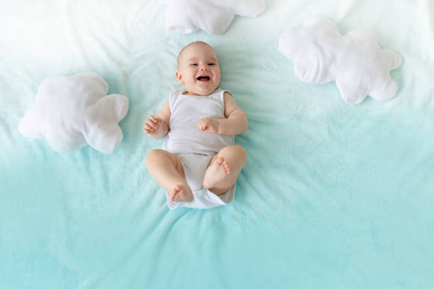 istock baby on a blue sky background with clouds laughing 1336862546