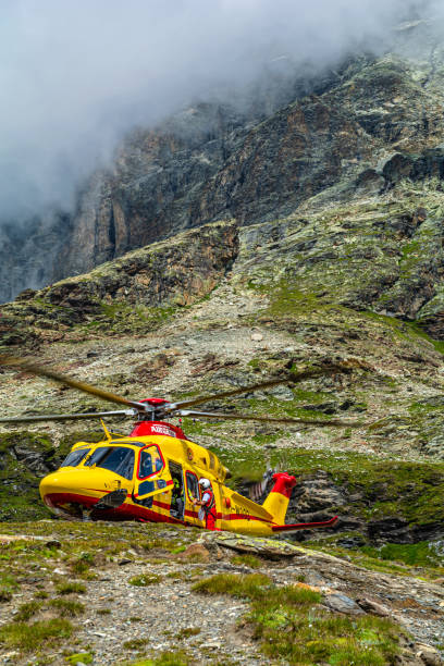 The intervention of the helicopter rescue at the Oriondè refuge in the high mountains (Cervinia – Valle d'Aosta Cervinia (Aosta Valley - Italy), Oriondè refuge, 18 August 2021: the intervention of the helicopter rescue to transport an injured mountaineer ski patrol photos stock pictures, royalty-free photos & images