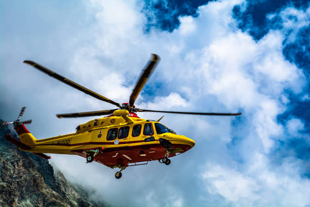 The intervention of the helicopter rescue at the Oriondè refuge in the high mountains (Cervinia – Valle d'Aosta Cervinia (Aosta Valley - Italy), Oriondè refuge, 18 August 2021: the intervention of the helicopter rescue to transport an injured mountaineer ski patrol photos stock pictures, royalty-free photos & images