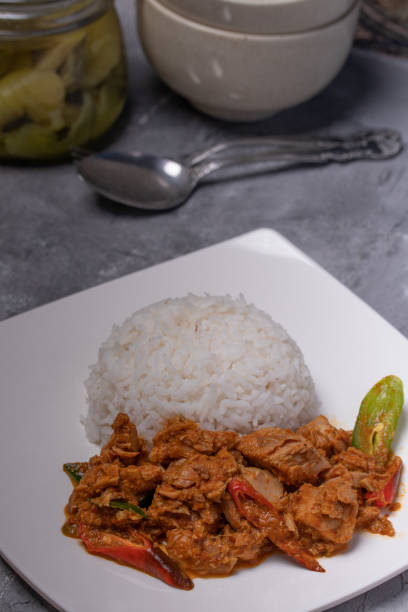 istock Stir-fried tuna with curry paste and steamed rice in a white plate 1336864169