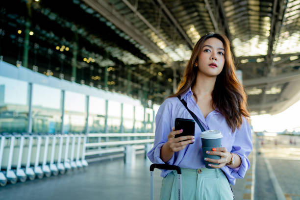istock Beautiful woman is calling a bus through an application. 1336865746