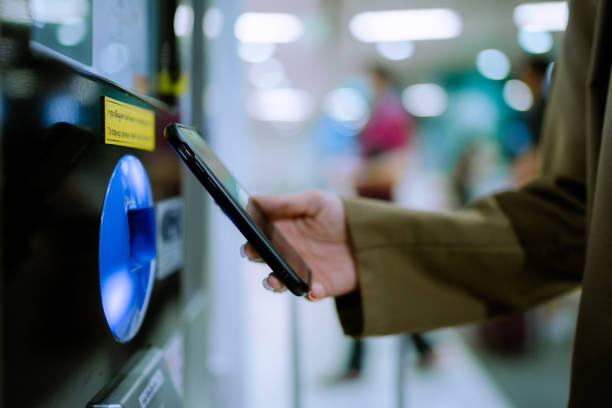 istock Woman scanning and paying with electronic devices 1336866640