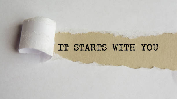 istock IT STARTS WITH YOU. words. text on grey paper on torn paper background 1336870212