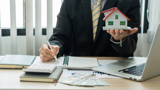 istock House plans with real estate agents and home purchase contract documents with calculator and laptop insurance concept or real estate loans 1336871521