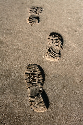 footprint shoe on beach brown sand texture print perspective
