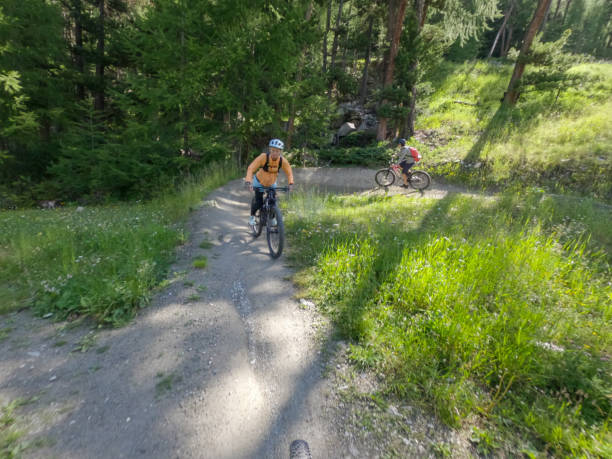 istock Female mountain biker rides along mountain trail. Front view 1336872772