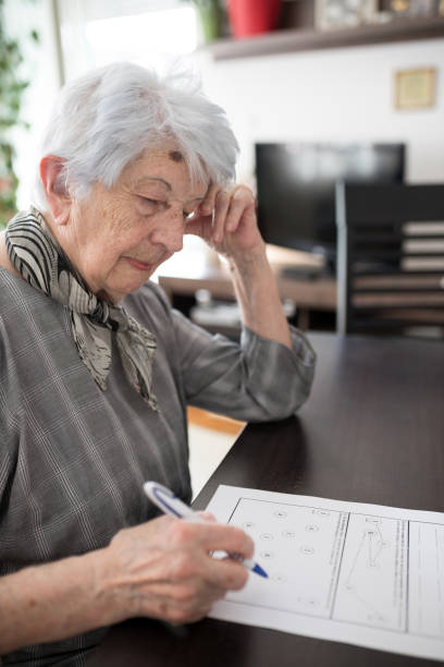 istock Worried senior woman doing Self-Administered Gerocognitive Examination test in her home 1336875295