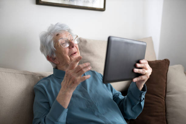 istock Happy senior woman using digital tablet for video call 1336875923