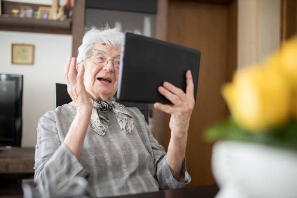 Senior woman making video call on a tablet