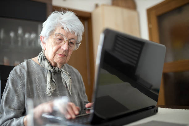istock Senior Caucasian woman browsing internet on a laptop at home 1336876830