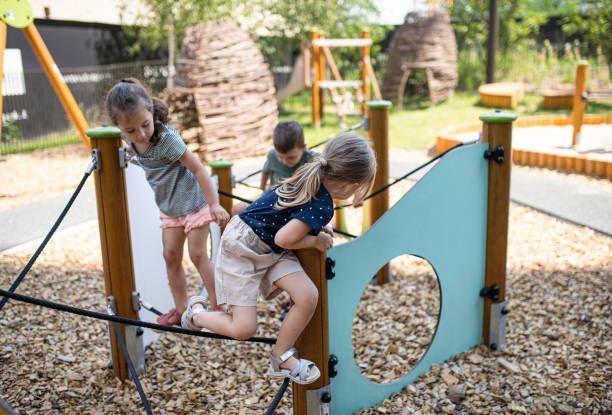 istock Group of small nursery school children playing outdoors on playground. 1336877871