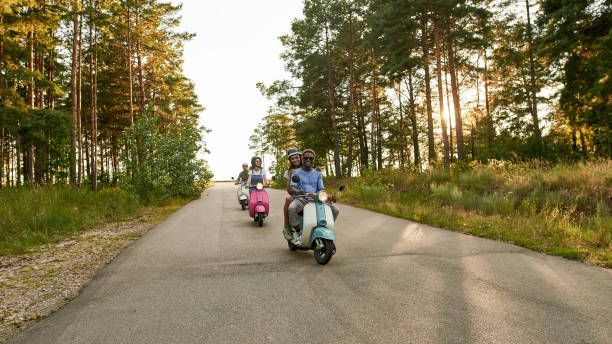 istock Smiling young multiracial people riding retro scooters 1336882119