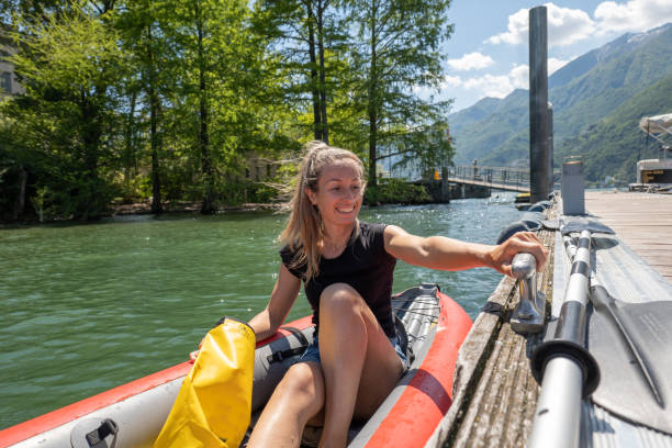 istock Young woman in red canoe getting on pier 1336882365