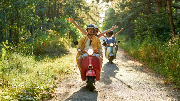 istock Happy young multiracial couples riding retro scooters 1336884151