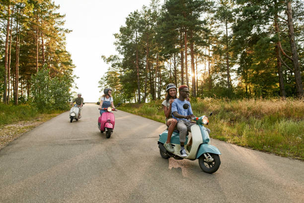 istock Happy young multiracial people riding colorful scooters 1336885325