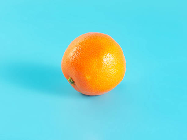 istock Orange tangerine on blue background 1336885552