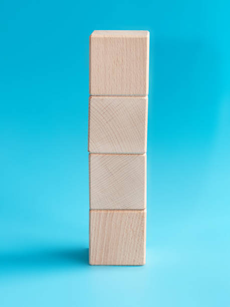 istock Wooden cube on blue background with space for text 1336885660