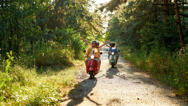 istock Happy young multiracial friends riding retro scooters 1336885814