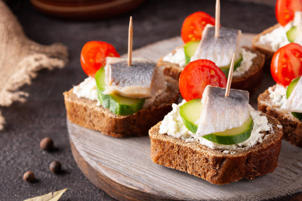istock herring sandwiches on wooden board on brown stone 1336890039
