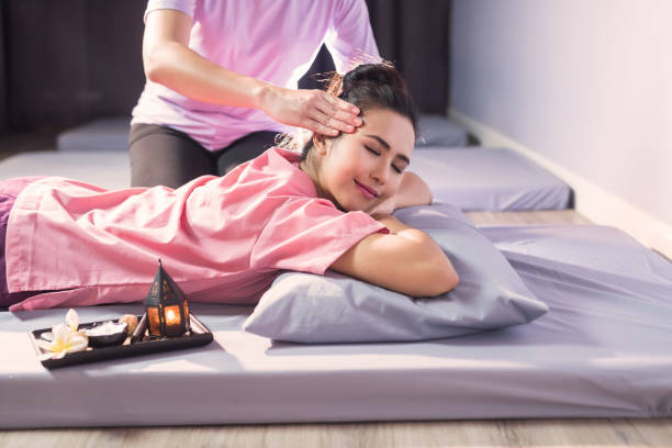 istock Thai head massage on bed in spa salon 1336891084