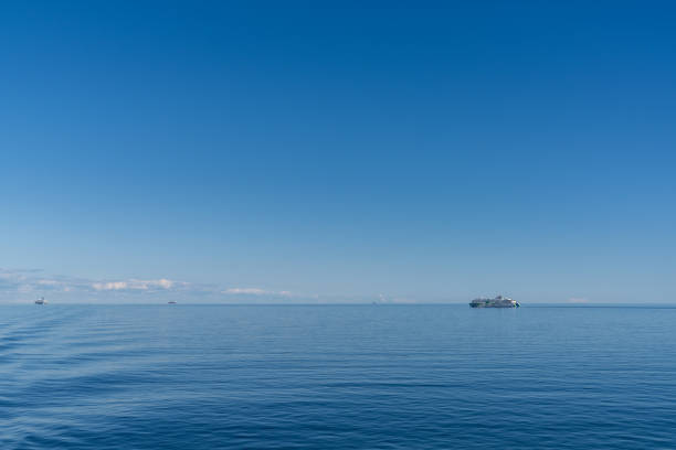 Helsinki, Finland: 5 August, 2021: calm blue open ocean under a blue sky with a large passenger ferry