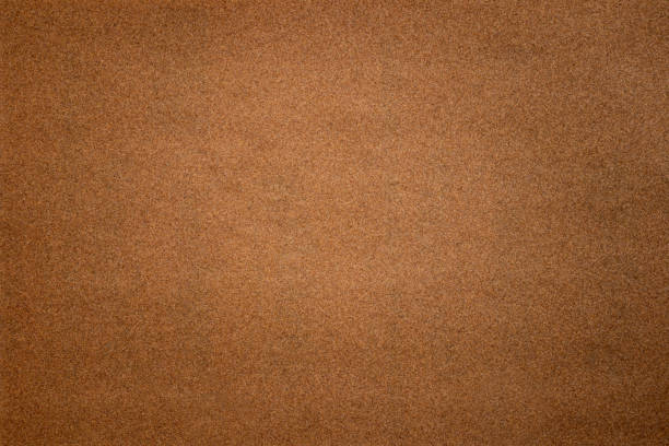 Sandpaper texture background where you can see the red-brown sand grain pattern on the sandpaper, suitable as a background for inserting text. Copy Space for designers to use on sandpaper.